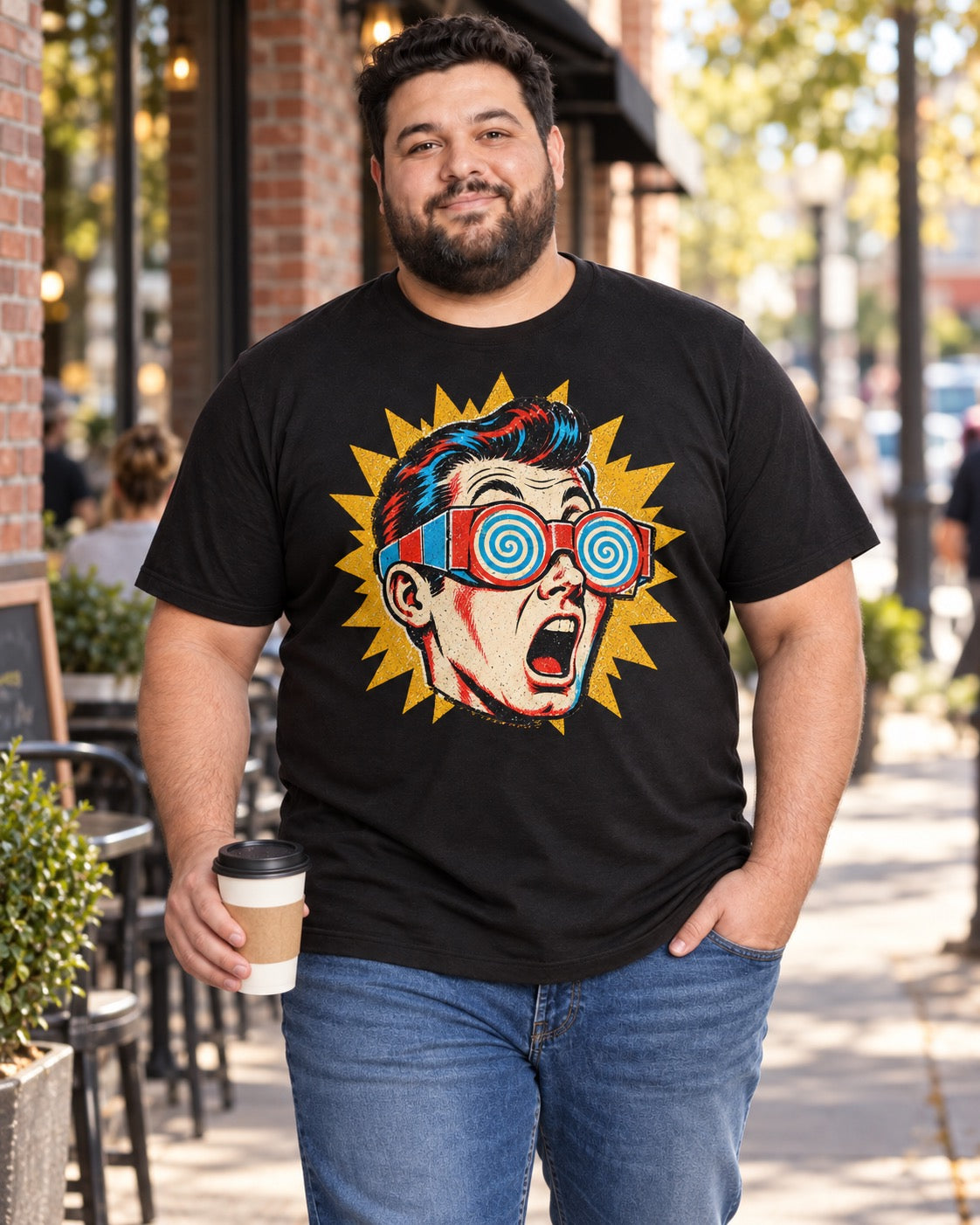 Man wearing men's black shocked pop-art guy t-shirt outside coffee shop on sidewalk